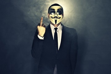 A man wearing mask shows middle finger