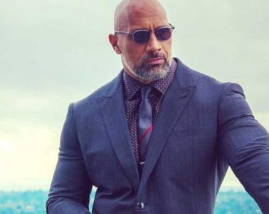 Dwayne The Rock Johnson in suit and sunglasses